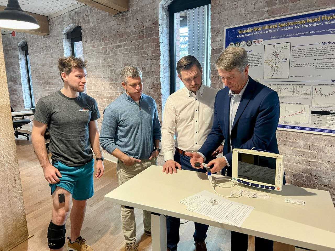 The NIRSense leadership team discussing its proprietary technology with American politician Rob Wittman and showing him how the patient monitors work.